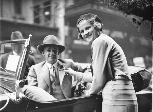 Poppy seller pins the flower on cricketer Don Bradman's lapel outside the State Theatre, Sydney, Remembrance Day, early 1930s / photograph by Sam Hood