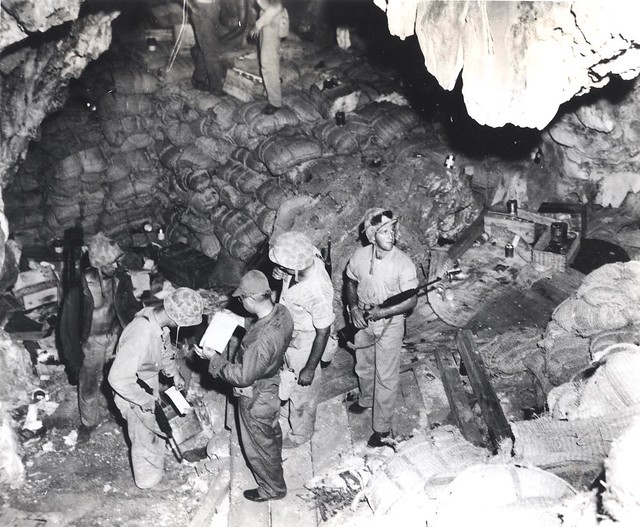 Marines securing storehouse of supplies in cave at Saipan, 1944