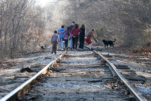 Family walking down a railway trail with a dog