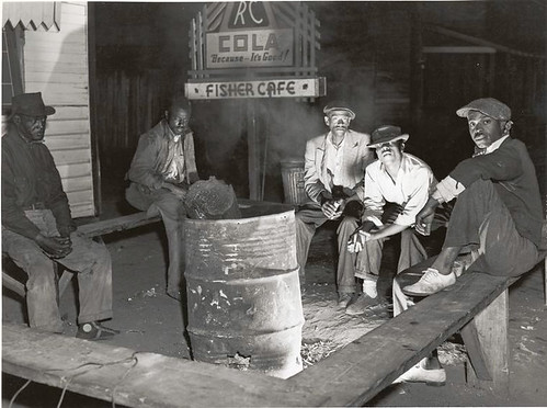 Negro laborers sitting around in front of a fire on Saturday...