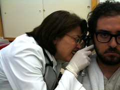 Doctor checking a patient's ear.