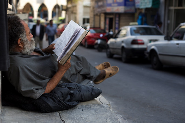 old Arab man reading book. Amman, Jordan