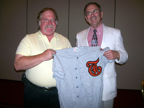 Dr. Russell Nichols receiving jersey from Greg Varga