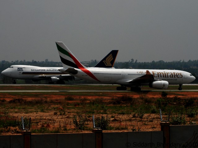 Singapore Cargo and Emirates tail cross