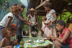 A family shares a meal of Mozambique tilapia, cabbage, potato and rice, Taflankwasa village, Malaita Province, Solomon Islands. Photo by Filip Milovac.
