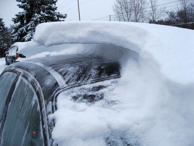 Snow wave over a car