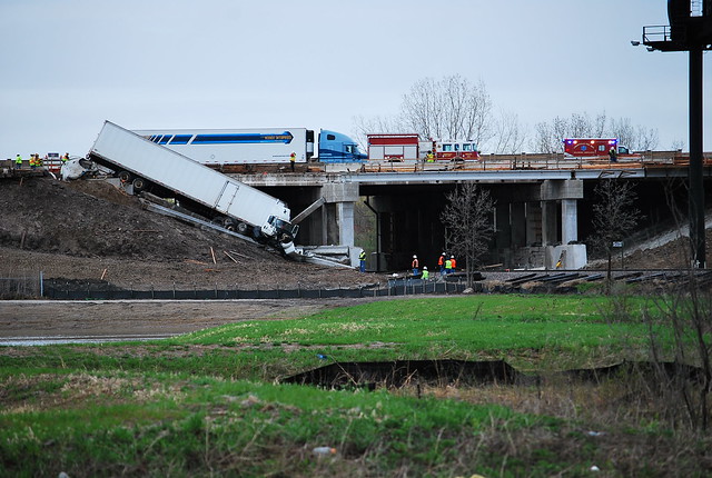 Truck accident with damaged tracks and bridge