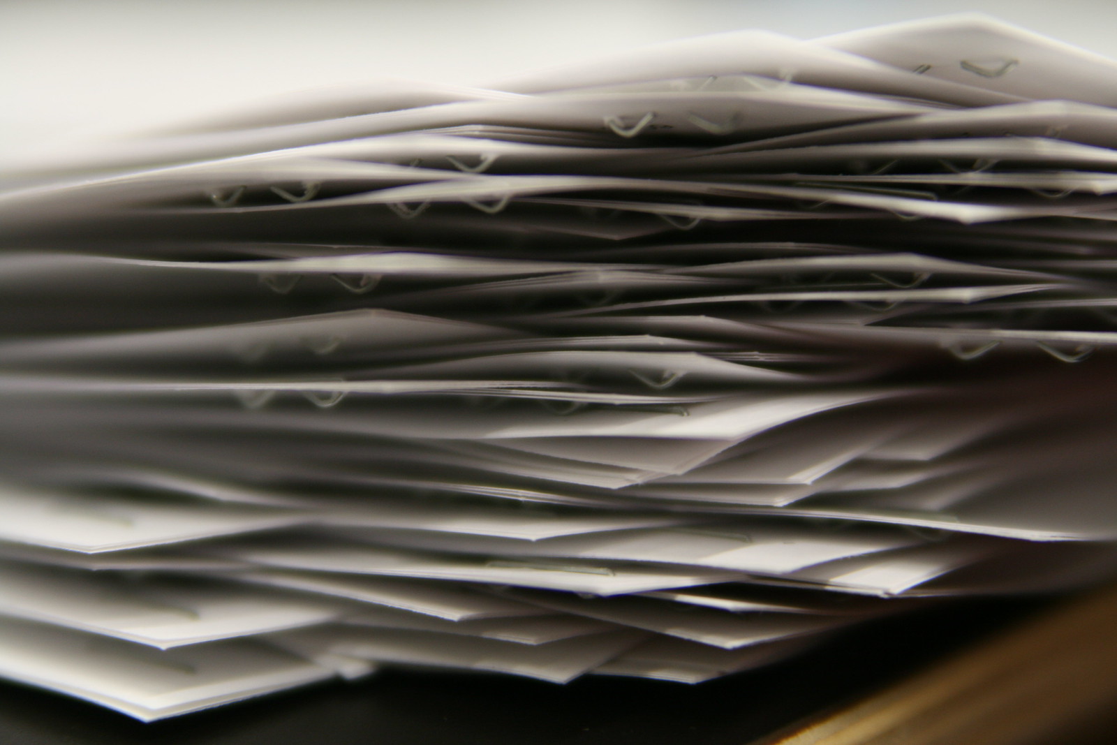 A pile of papers on a desk.