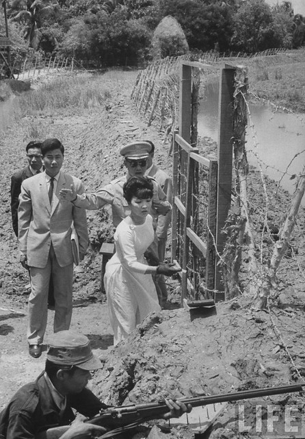 7-1962 Mrs. Dinh Nhu Ngo, Vietnams's First Lady, inspecting perimeter defenses.
