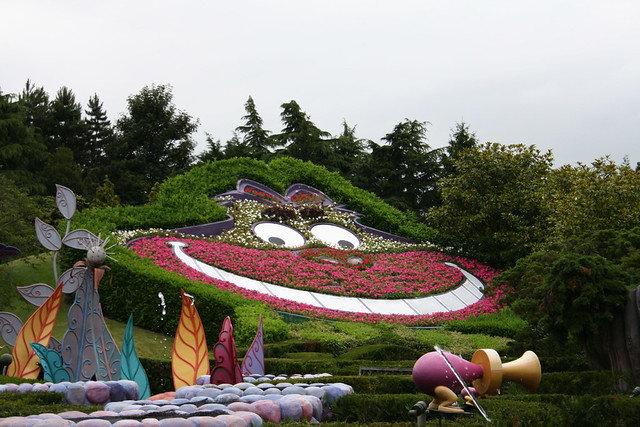 The Cheshire Cat smiles it with flowers