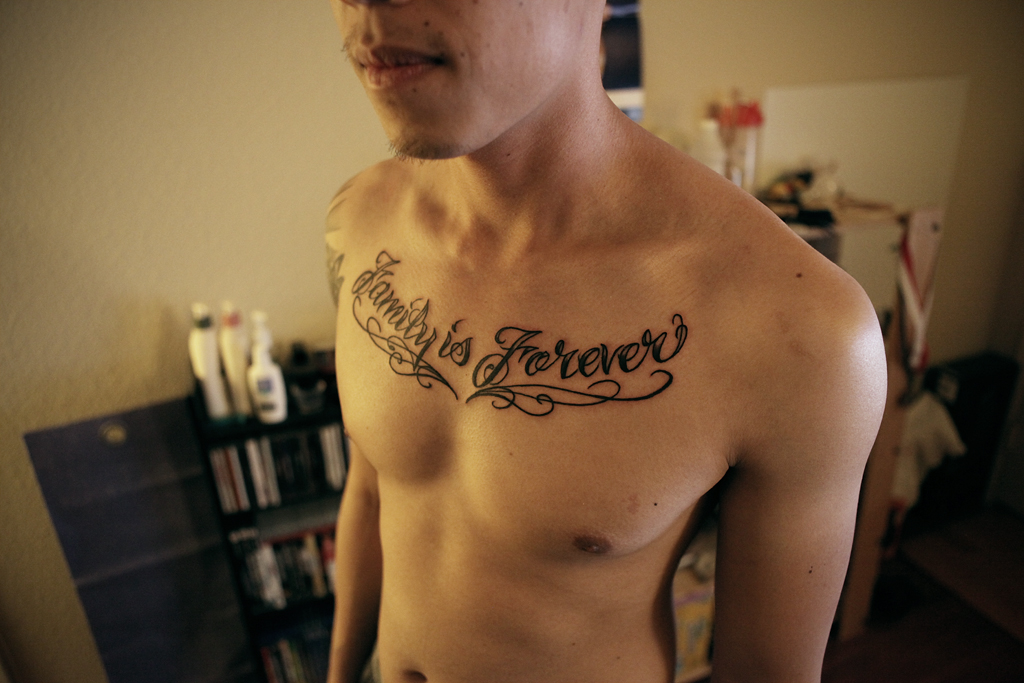 chest piece tattoo - "family is forever" .