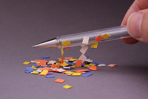 Static Electricity on a pen picking up bits of paper | by Eric Schrader