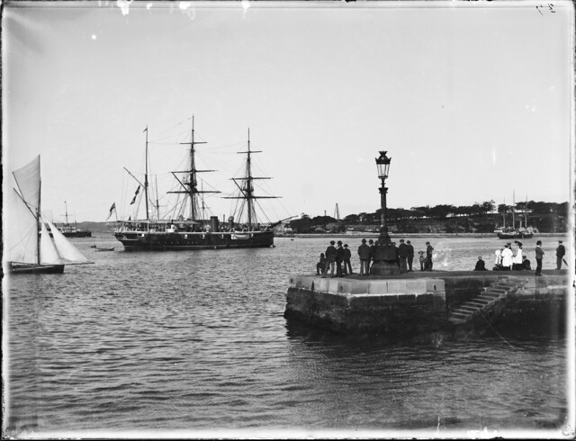 Group on Man O' War steps, Sydney harbour, HMS Royalist in foreground