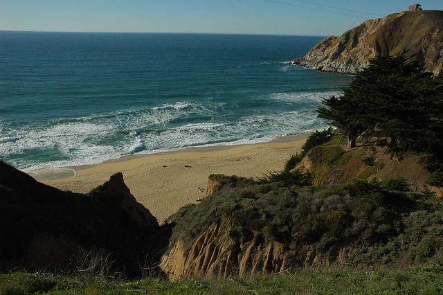 Pacific ocean beach, Gray Whale Cove, from above, WW11 bunker on the distant hill, near San Francisco, California, USA