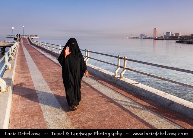 Saudi Arabia - Woman in traditional Abaya on Jeddah Corniche
