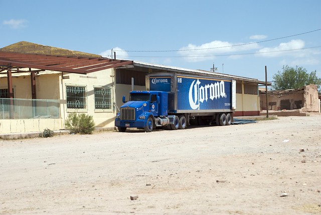 Corona Truck Parked Next to an Abandoned Building