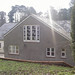 Existing cob house. Built two storey extension, using reclaimed slates to match. Built brick retaining wall and patio.