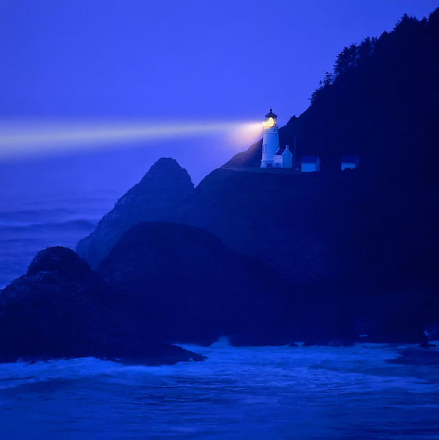 Lighthouse beams across stormy night sea - Heceta Head, Oregon Coast