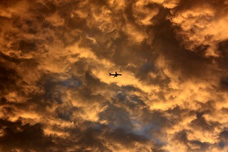 Plane In Clouds - Sunset