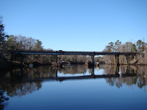 blue winter sky reflection water glass highway piers pines cypress buoy