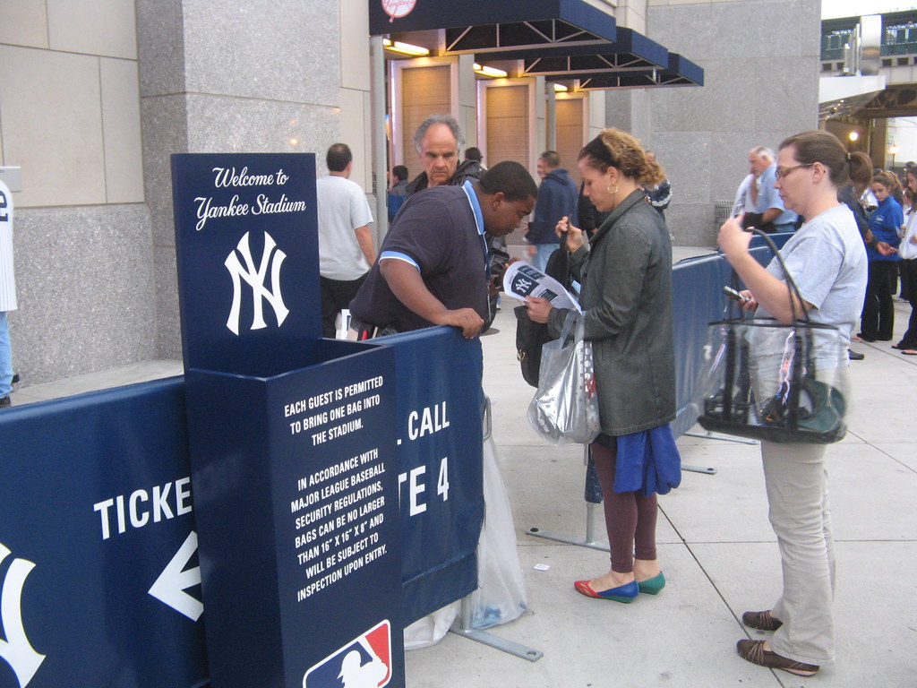 Yankee Stadium, 09/16/09: security guy searches a woman's …