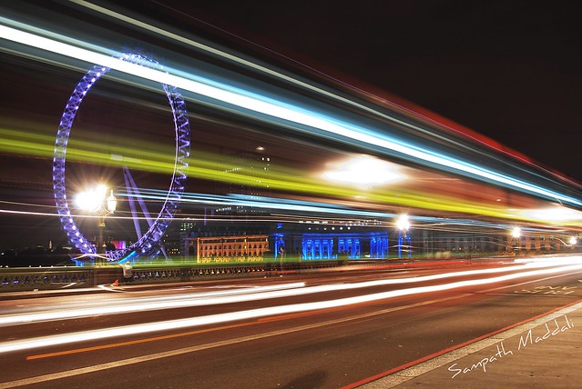 London eye at night through a Bus