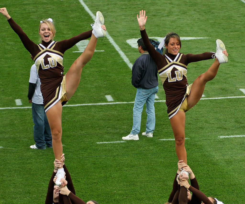 Cheerleader Co-captains with acrobatic move.