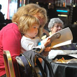 Getting to grips with the brochure | Mum and toddler browsing the programme 