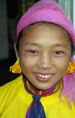 Tribal girl with flowers in their earings; Menghum, Xishuangbanna, Yunnan, China
