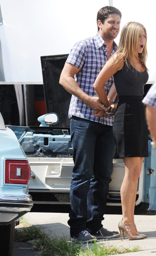 Jennifer Aniston handcuffed on movie set.