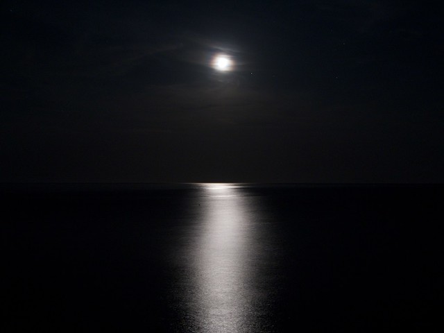 The Moon in the dark over the sea