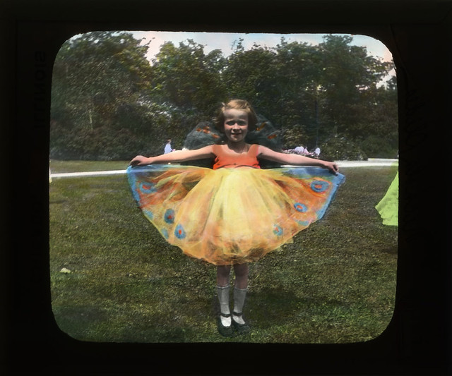 Color photograph of a girl dressed like flower or butterfly