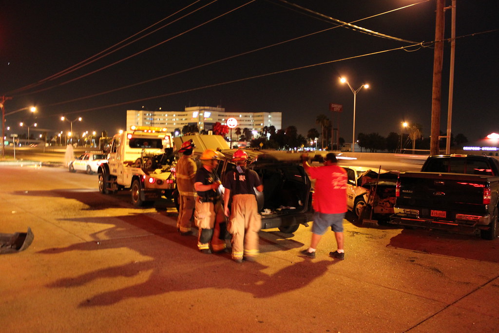 People Standing Around a Car Accident at Night