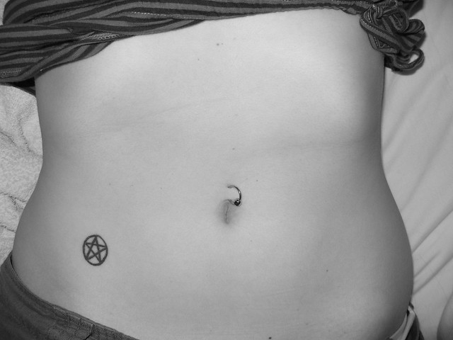 Pentagram Tattoo and Navel Piercing