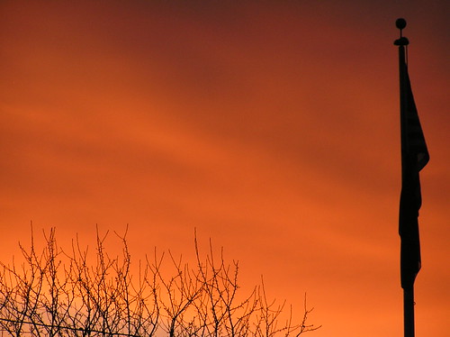 sunset orange sun tree clouds oregon flag branches vivid flagpole setting treebranches lagrande lagrandeoregon easternoregon lagrandeor