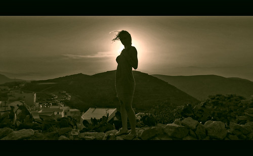 woman monochrome island cyclades aegean greece hellas summer sun sunset wind windy hill sea villagescape