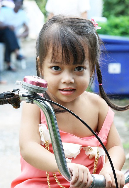 cute girl on her tricycle