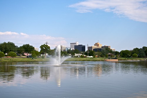 blue trees sky green water fountain grass skyline clouds buildings pond tx midland