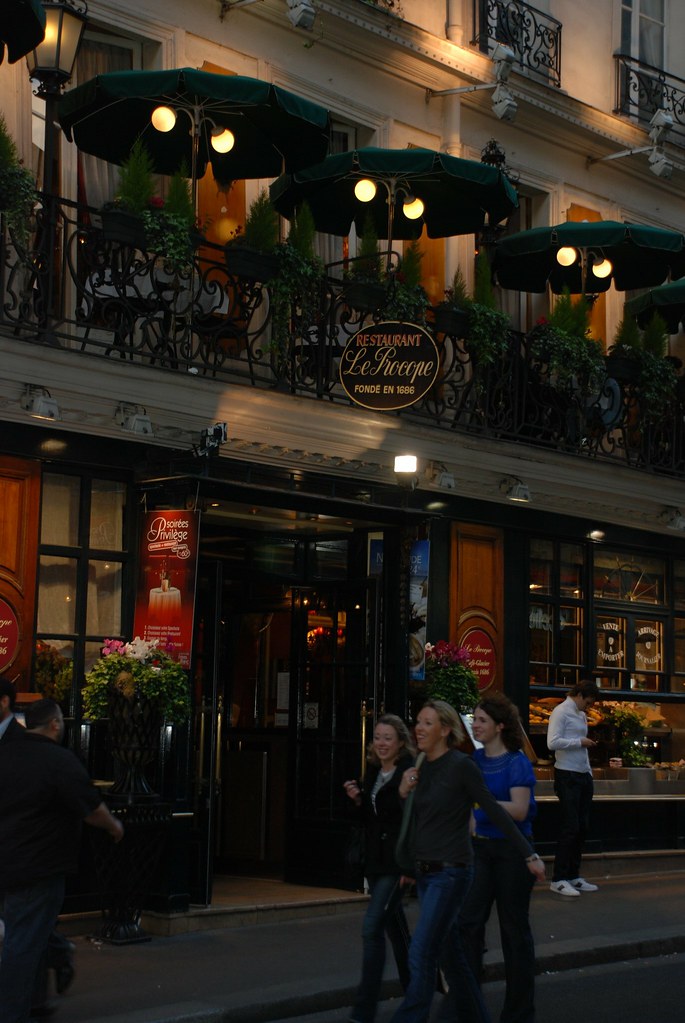 The flower-lined entrance of Le Procope in Paris