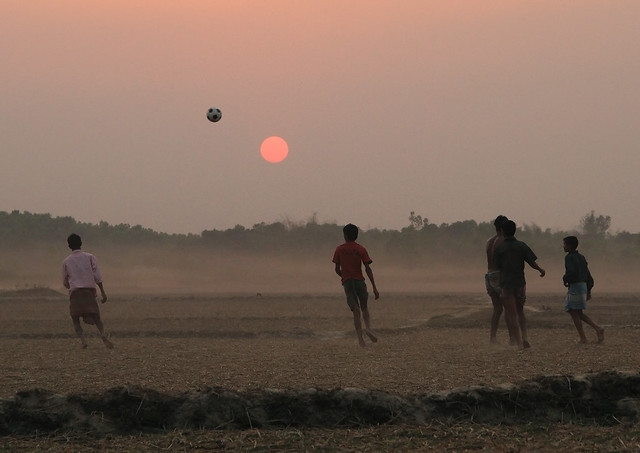 Rural foodball play during sunset