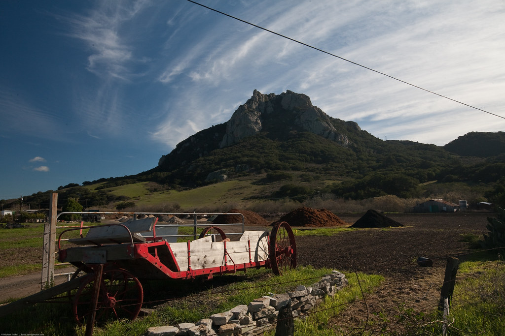 Hollister Peak seen here with a red hay wagon, is one of the Nine Sisters