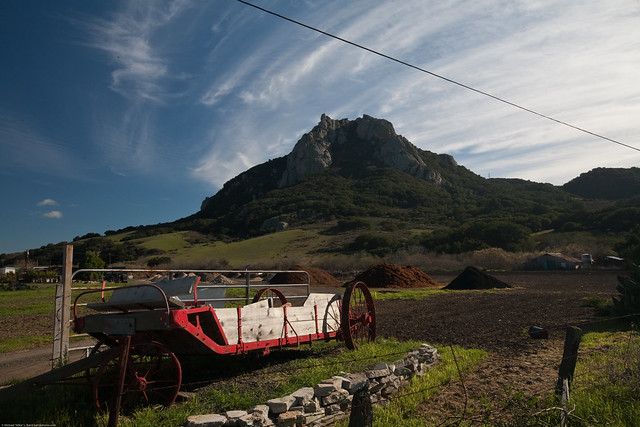Hollister Peak seen here with a red hay wagon, is one of the Nine Sisters