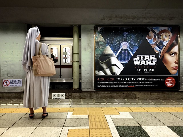 Japanese Nun Gazes at a Poster for Star Wars