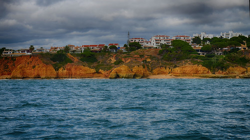 ocean houses homes sea cliff color building home portugal architecture clouds buildings coast colorful day view cloudy cliffs atlantic coastline algarve development hdr rugged the