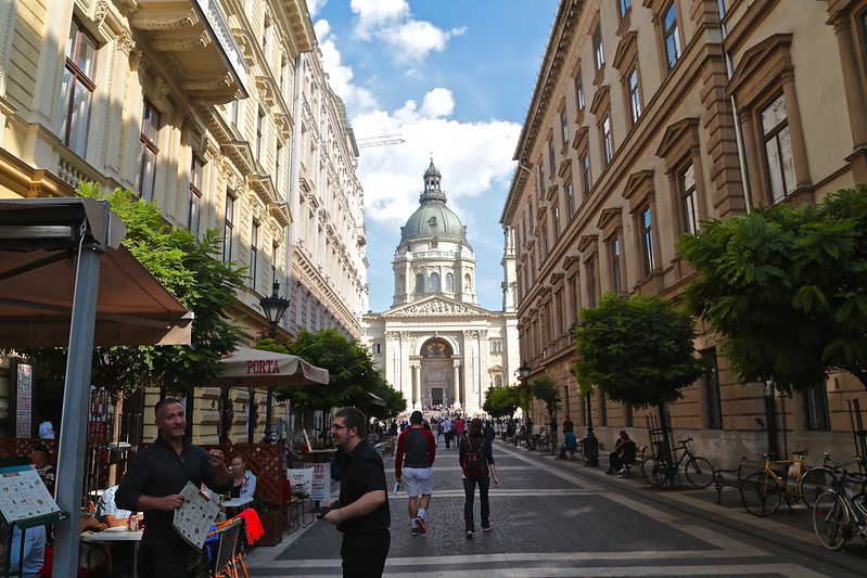 A Cheerful Waiter and a View of Saint Stephen's Basilica