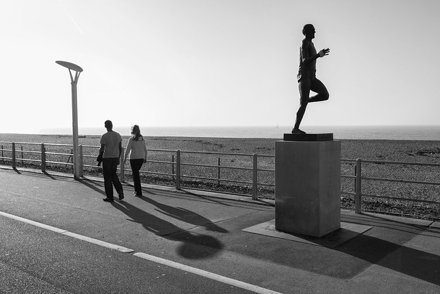 Two companions and a runner in Brighton