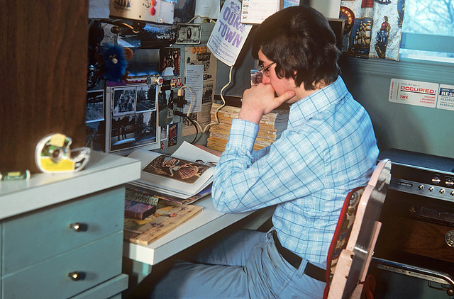A nerdy looking 17 year old me at my desk with a stack of vintage National Geographic magazines, posters and photos on the wall. Milford Connecticut. June 1976.