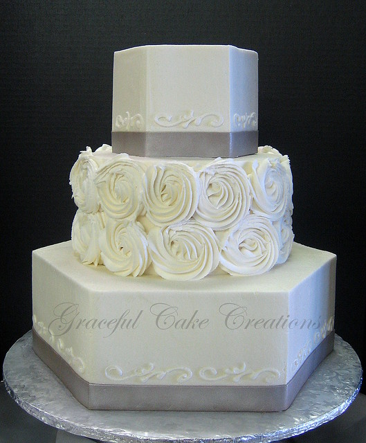 Elegant Ivory Wedding Cake with Rosettes and Taupe Ribbon