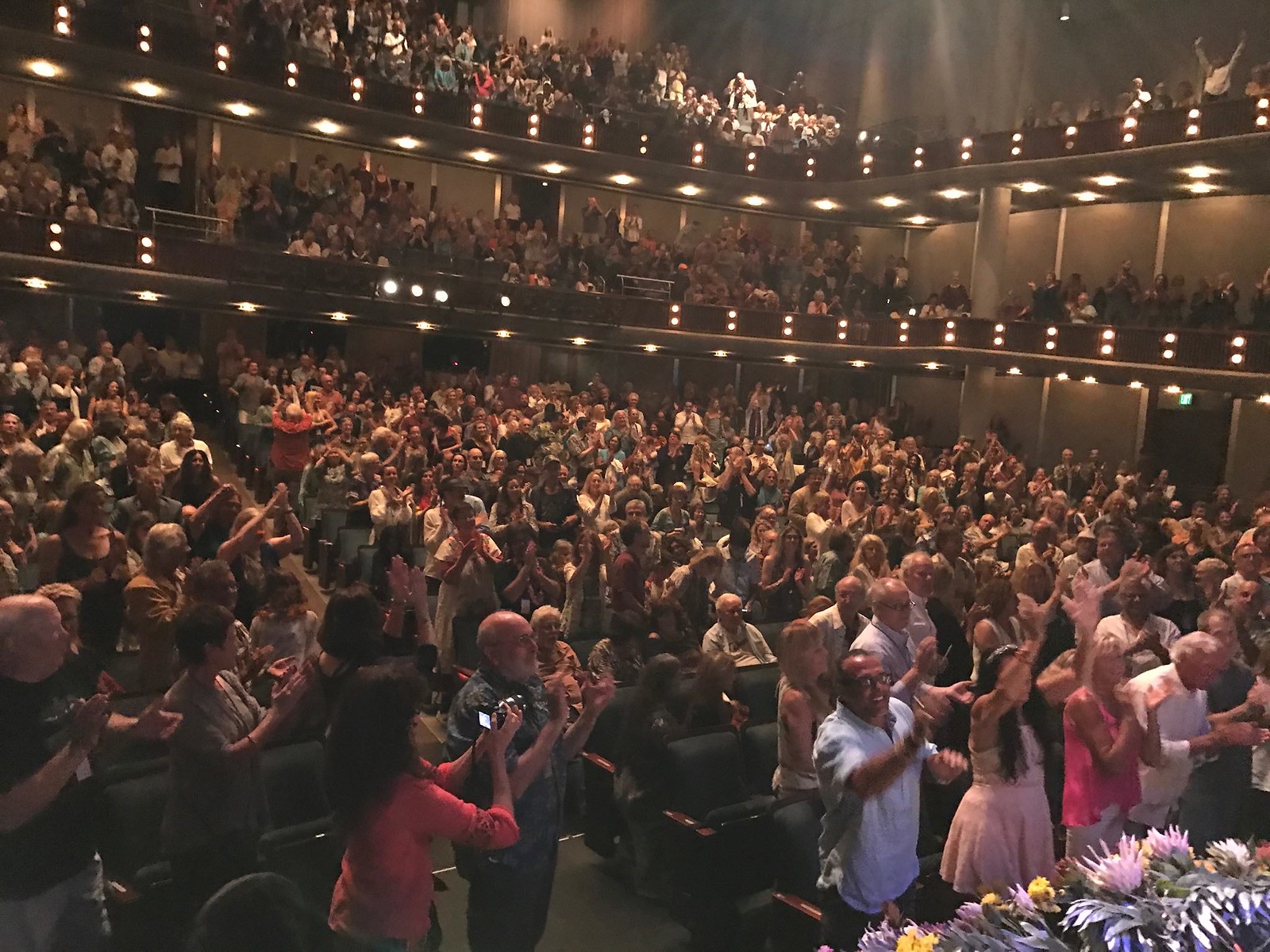 A sold-out crowd at the Maui Arts and Cultural Center honors Ram Dass with a standing ovation.