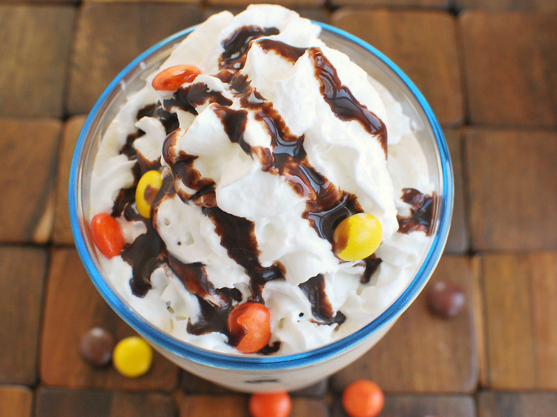 Reese's Pieces Milkshake - homemade peanut butter milkshakes with Reese's Pieces candy! Only 4 ingredients! Top it with whipped cream, chocolate syrup, and more candy for the most decadent treat. 